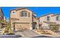 Inviting home exterior with well-maintained landscaping, two-car garage and a welcoming front entrance at 10940 Oregano Ave, Las Vegas, NV 89166