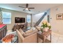 Bright living room features a decorative fireplace, a comfortable sofa, and large windows at 10940 Oregano Ave, Las Vegas, NV 89166