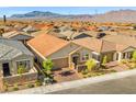 Expansive aerial view of a desert community, showcasing single-story homes with mountain views in the background at 10972 Nicholas Jay Ave, Las Vegas, NV 89166