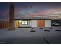Charming single-story home with desert landscaping, a yellow door, and ample parking at 1209 S 17Th St, Las Vegas, NV 89104
