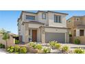 Charming two-story home with a gray stucco exterior, a two car garage, and a beautifully landscaped front yard at 12413 Alpenglow Ct, Las Vegas, NV 89138