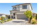 Well-maintained two-story home with a brick driveway, two-car garage, and a lovely landscaped yard at 12413 Alpenglow Ct, Las Vegas, NV 89138
