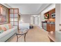 Comfortable living area with sofa, glass coffee table, and kitchenette with modern stainless steel appliances at 145 E Harmon Ave # 3801&3803, Las Vegas, NV 89109