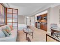 Comfortable living area with sofa, glass coffee table, and kitchenette with modern stainless steel appliances at 145 E Harmon Ave # 3801&3803, Las Vegas, NV 89109