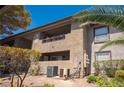 Exterior shot of a condo building showcasing the architecture and desert landscape at 2606 S Durango Dr # 122, Las Vegas, NV 89117