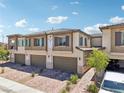 Beautiful two-story townhome boasts a two-car garage and inviting curb appeal at 267 Cordelia Cove Ave # 812, Henderson, NV 89011