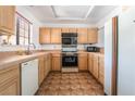 Functional kitchen features tile countertops, wood cabinets, and essential appliances, providing a practical space for cooking at 2851 S Valley View Blvd # 2148, Las Vegas, NV 89102