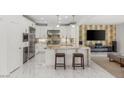 Open-concept kitchen featuring stainless steel appliances, granite countertops, and a breakfast bar perfect for dining at 2940 Cimini Ct, Henderson, NV 89052