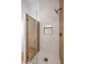 Modern shower with sleek glass door, mosaic floor, and recessed shelf at 3104 Waterview Dr, Las Vegas, NV 89117