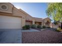 Single-story home featuring desert landscaping, a tile roof, and a two-car garage with an extended driveway at 3105 Birch Hill Ct, Las Vegas, NV 89134