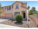 Inviting two-story home featuring a well-kept yard with desert landscaping and a quaint covered porch at 3194 Lapis Beach Dr, Las Vegas, NV 89117