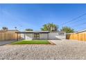 Spacious backyard featuring a covered patio, freshly laid grass, and minimalist landscaping for outdoor enjoyment at 333 Rossmoyne Ave, North Las Vegas, NV 89030