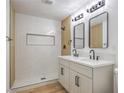 Contemporary bathroom showcasing a double vanity, walk-in shower with tile surround, and modern fixtures at 333 Rossmoyne Ave, North Las Vegas, NV 89030