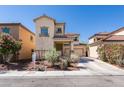 Charming two-story stucco home featuring a desert landscape, tile roof, and attached two-car garage at 3553 Terneza Ave, North Las Vegas, NV 89081