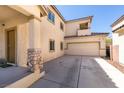 Charming two-story stucco home with desert landscape, tile roof, attached two-car garage, and covered porch at 3553 Terneza Ave, North Las Vegas, NV 89081