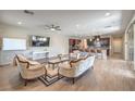 Spacious living room boasts hardwood floors, modern ceiling fan, and access to the kitchen at 406 Gracious Way, Henderson, NV 89011