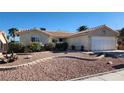 Single story home featuring desert landscaping with gravel, stone accents, and shrubs at 4285 El Como Way, Las Vegas, NV 89121