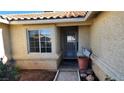 The home's entry features a secure gate, a window, and desert landscaping at 4285 El Como Way, Las Vegas, NV 89121