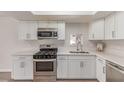 Stylish kitchen featuring stainless steel appliances and white cabinetry at 4745 Madrigal Way, Las Vegas, NV 89122