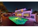 A backyard with a pool, hot tub, and covered patio, perfect for outdoor entertaining at 4835 Illustrious St, Las Vegas, NV 89147