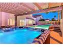 A luxurious hot tub with a pergola and views of the pool and backyard at 4835 Illustrious St, Las Vegas, NV 89147