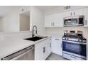 Bright kitchen with stainless steel appliances, white cabinets, and quartz countertops at 5217 Caspian Springs Dr # 101, Las Vegas, NV 89120