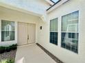 Inviting front entrance with double doors, decorative windows, and a well-maintained walkway at 5422 Nestled Moon Ct, Las Vegas, NV 89131