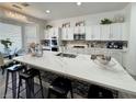 Modern kitchen with a large center island, white cabinets, and stainless steel appliances at 5422 Nestled Moon Ct, Las Vegas, NV 89131
