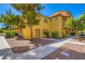 Beautiful multi-level townhouse with balcony and landscaped grounds, creating an inviting curb appeal at 5915 Nuevo Leon St # 8, North Las Vegas, NV 89031