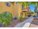 Charming townhouse featuring a balcony, shuttered windows and landscaped grounds, creating an inviting curb appeal at 5915 Nuevo Leon St # 8, North Las Vegas, NV 89031
