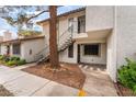 Charming condo exterior featuring staircase, mature tree and ample space at 6711 W Charleston Blvd # 2, Las Vegas, NV 89146
