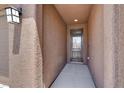 A welcoming front door with a decorative light fixture and textured walls at 7428 Alamo Ranch Ave, Las Vegas, NV 89179