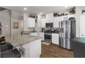 Modern kitchen with stainless steel appliances, granite countertops, and white cabinetry at 7515 Emerald Stars St # 102, North Las Vegas, NV 89084