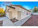 Side view of house with a two car garage, desert landscaping and tiled roof at 7849 Montour Falls St, Las Vegas, NV 89149