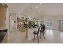 Open concept kitchen with a large island, recessed lighting, and an adjacent living space at 8356 Shady Lady Ct, Las Vegas, NV 89131