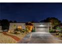 Charming single-story home at night featuring desert landscaping, stucco walls, and a two-car garage at 853 Morning Sun Ct, Las Vegas, NV 89110