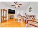 Cozy living room with fireplace, hardwood floors, and ample seating at 930 High Plains Dr, Henderson, NV 89002