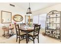 Bright dining room featuring a round table with seating for four and decorative display shelves at 9921 Woodhouse Dr, Las Vegas, NV 89134