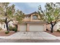 Two-story home featuring a two-car garage, landscaped front yard, and warm exterior at 1124 Coral Rainbow Ave, Las Vegas, NV 89123