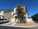 Inviting two-story home with a tile roof, a tree in front, and street view at 1310 Golden Apple St, Las Vegas, NV 89142