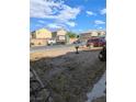 Backyard area with a fence and neighboring houses visible in the background at 1655 N Gateway Rd, Las Vegas, NV 89115