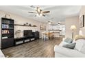 Inviting living room with wood floors, a ceiling fan and a view into the modern kitchen at 2040 Bavington Dr # D, Las Vegas, NV 89108