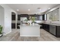 Well-lit kitchen with dark cabinetry, stainless steel appliances, and granite countertops at 2332 Mundare Dr, Henderson, NV 89002