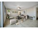 Bright living room featuring neutral tones, tile flooring, and modern decor at 2332 Mundare Dr, Henderson, NV 89002