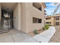Exterior view of a multi-story home with concrete sidewalks, steps, and landscaping with green shrubbery at 2451 N Rainbow Blvd # 1066, Las Vegas, NV 89108