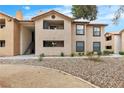 Exterior view of the multi-story home with a combination of stucco facade and a balcony in a well-maintained yard at 2451 N Rainbow Blvd # 1066, Las Vegas, NV 89108