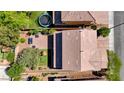 Overhead view of backyard with trampoline, seating, playset, manicured landscaping, and brick patio at 2544 Sable Ridge St, Henderson, NV 89044