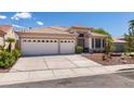 Attractive one-story home showcasing a spacious driveway and a two-car garage at 2587 Grizzly Park Ct, Henderson, NV 89052