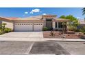 Charming single-story home featuring desert landscaping, a spacious driveway, and a two-car garage at 2587 Grizzly Park Ct, Henderson, NV 89052