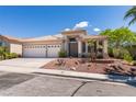 Inviting single-story home with drought-tolerant landscaping and a spacious driveway leading to a two-car garage at 2587 Grizzly Park Ct, Henderson, NV 89052
